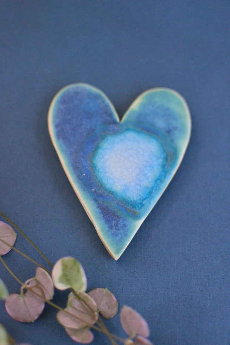 Ceramics heart glazed in blues and turquoise designed to hang on the wall