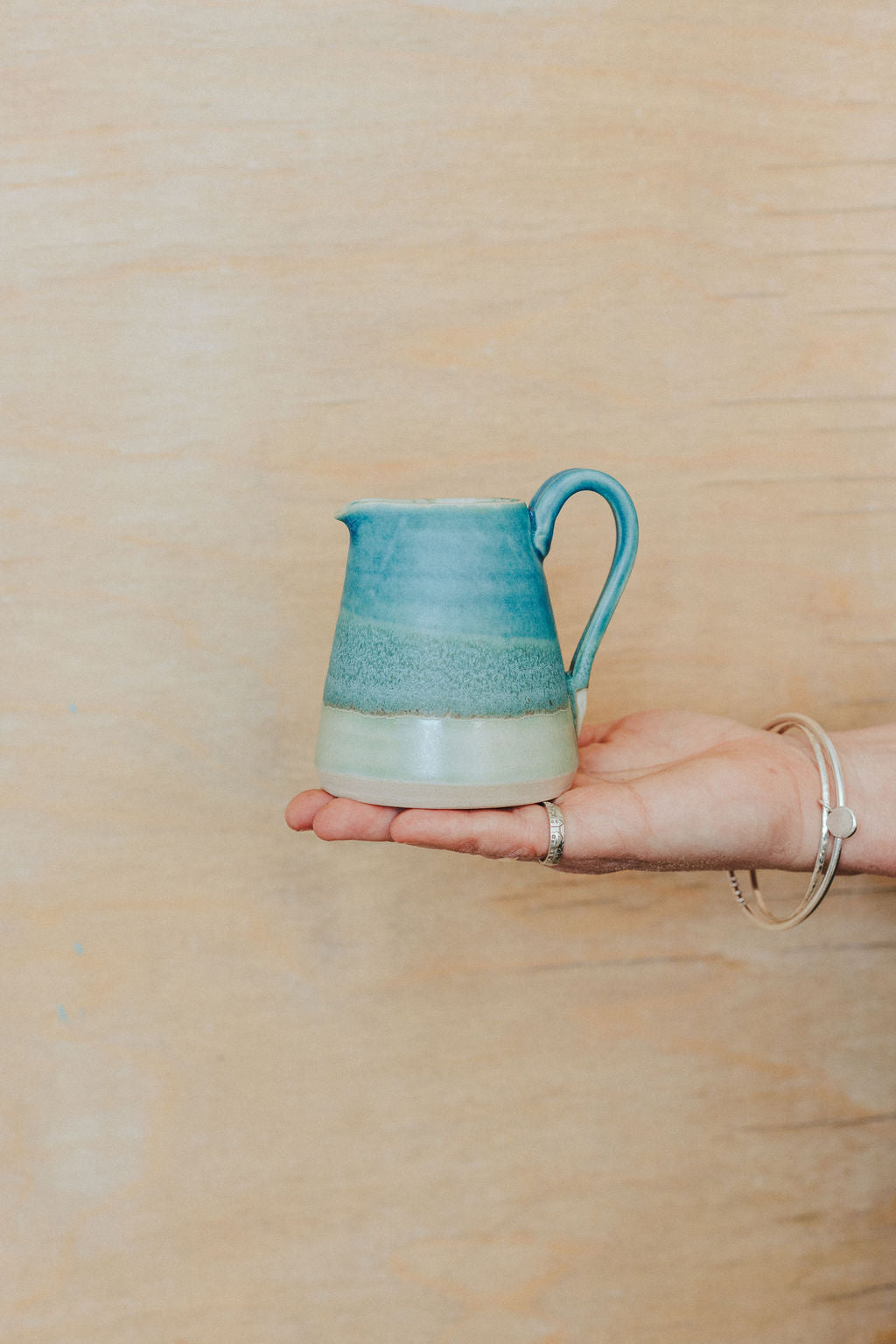 Handmade ceramic small jug - decorated in blues and turquoise glazes